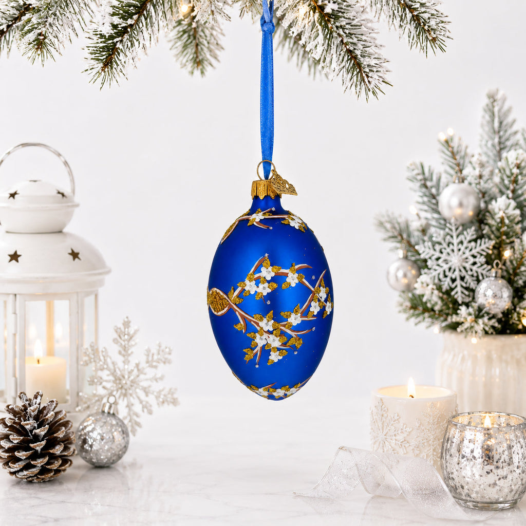 White Blossom Branch on Blue Glass Egg Ornament