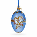 White Blossom Branch on Light Blue Glass Egg Ornament