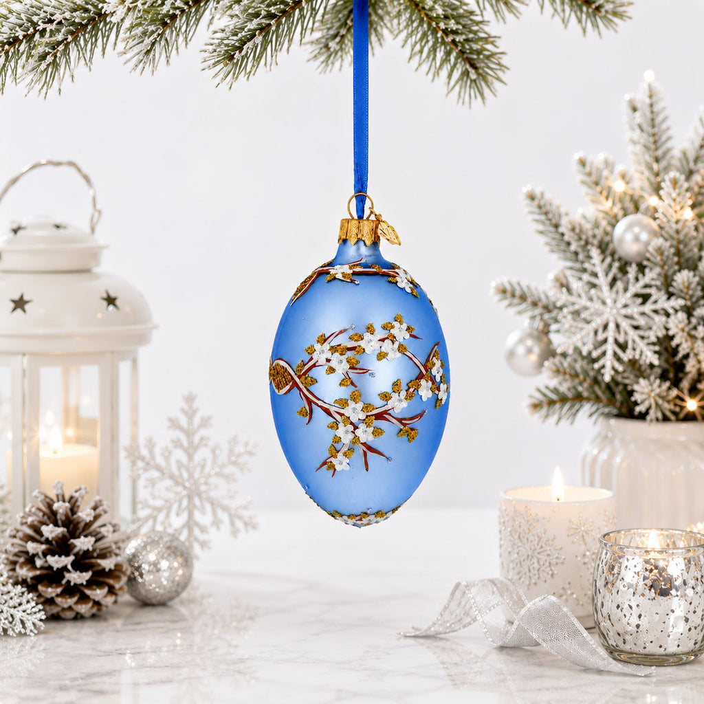 White Blossom Branch on Light Blue Glass Egg Ornament