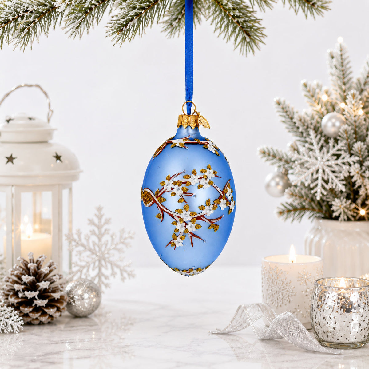 White Blossom Branch on Light Blue Glass Egg Ornament